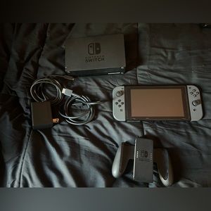 Nintendo Switch (Used) with screen protector on it